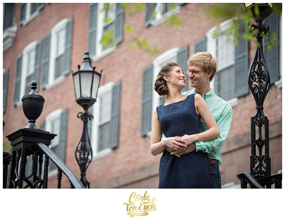A couple embraces on the campus of Yale during their engagement session in New Haven CT