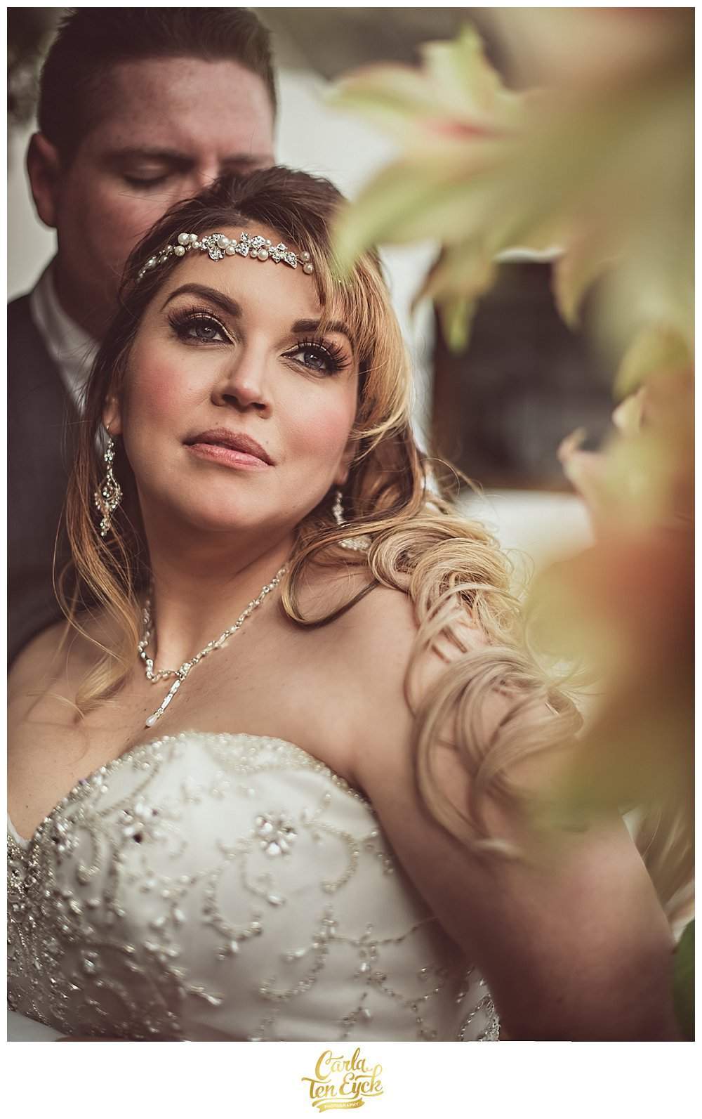 Bride poses with her groom in the greenhouse at Hopkins Vineyard CT after their vow renewal.