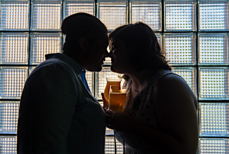 Two women embrace at their engagement session at The Hog River Brewery in Hartford CT