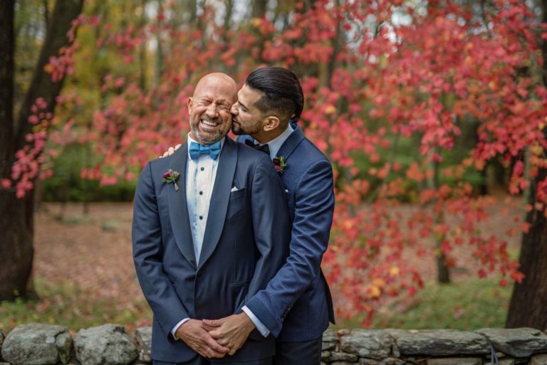 Two grooms laugh at their fall wedding at Lord Thompson Manor Thompson CT