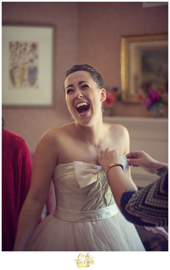 A bride laughs at her wedding at The Bee and Thistle Inn in Old Lyme CT