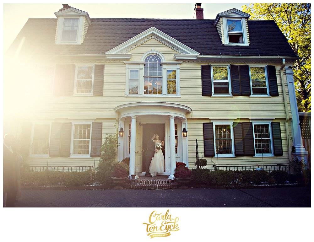 A bride and groom in the doorway of the Bee and Thistle Inn wedding in Old Lyme CT