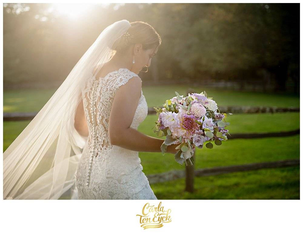 Smiling bride walks in her lace Maggie Sottero wedding gown at Tyrone Farm, Pomfret CT