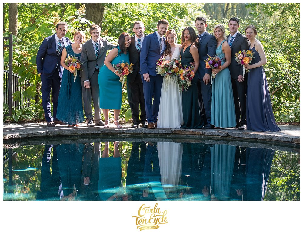 Teal wedding party by a swimming pool at a wedding in Norwalk CT with Amy Champagne Events.