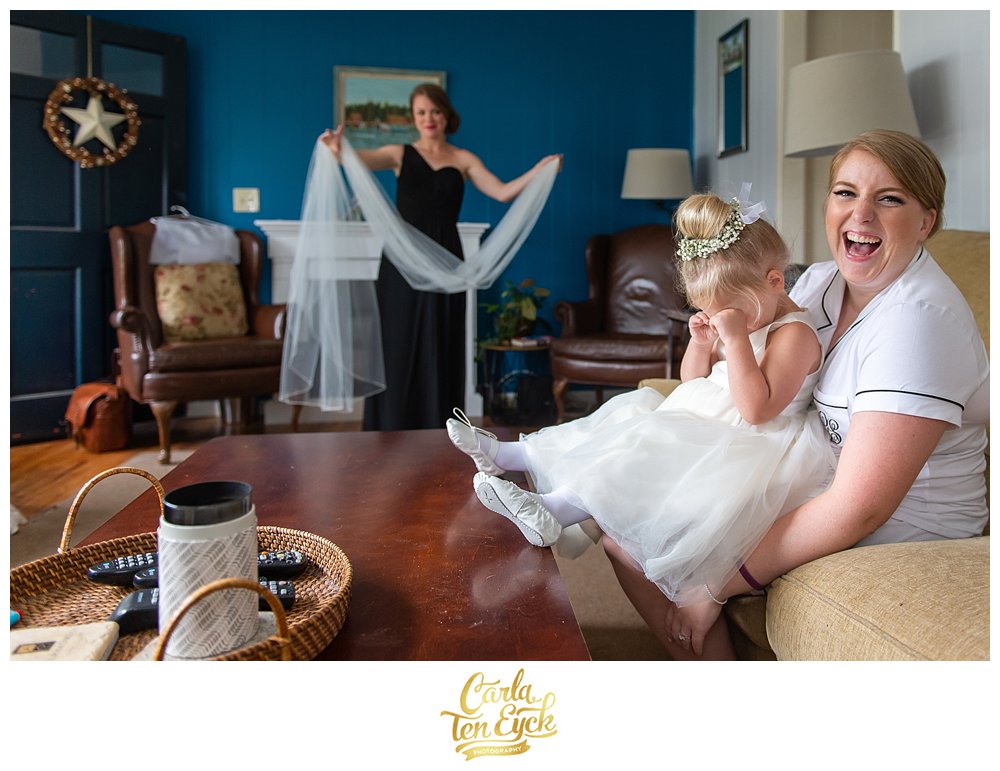 Bride laughs with her flower girl at her wedding day in Lordship CT