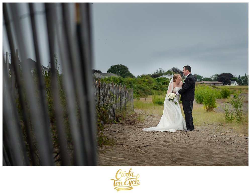 Bride laughs on the beach at her wedding in Lordship CT