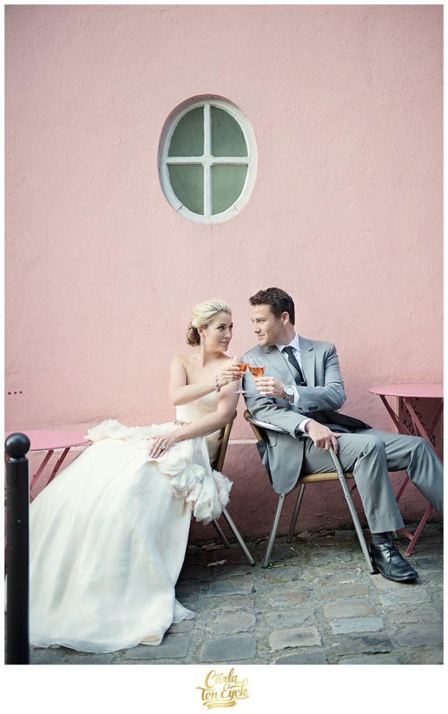 Bride and groom toast with rose at La Maison Rose in Montmartre Paris France
