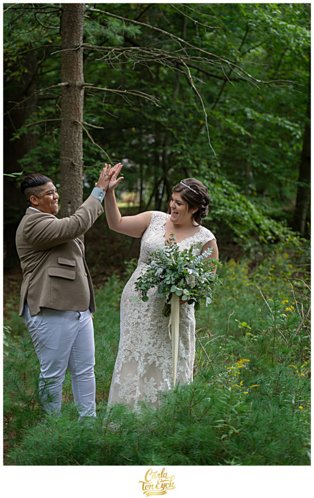Two brides high five on their wedding day in Glastonbury CT
