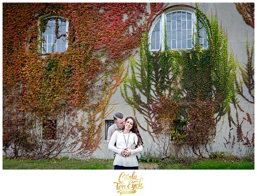 Engaged couple embrace by ivy at Harkness Park in Waterford CT
