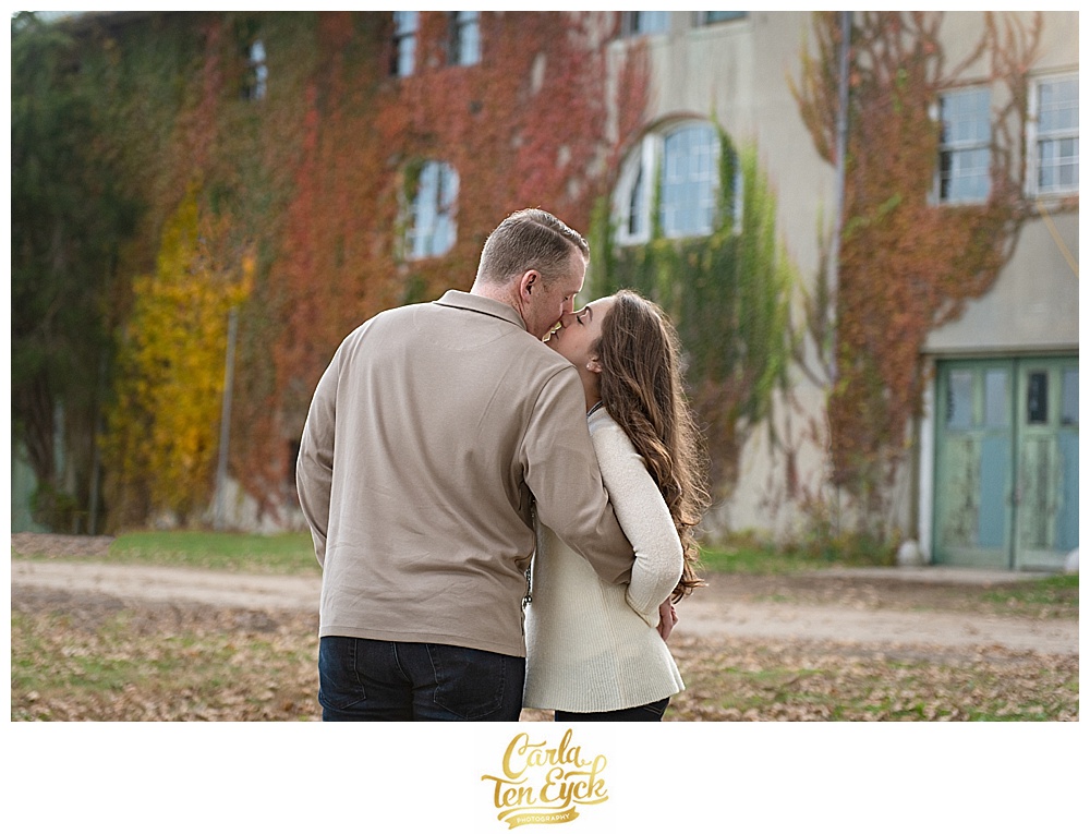 A couple embraces at their Autumn engagement session at Harkness Park Waterford CT