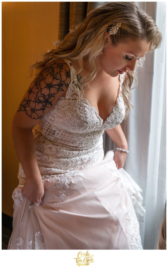 Beautiful bride slips her shoes on in her Stella York wedding gown at Aria in Prospect CT