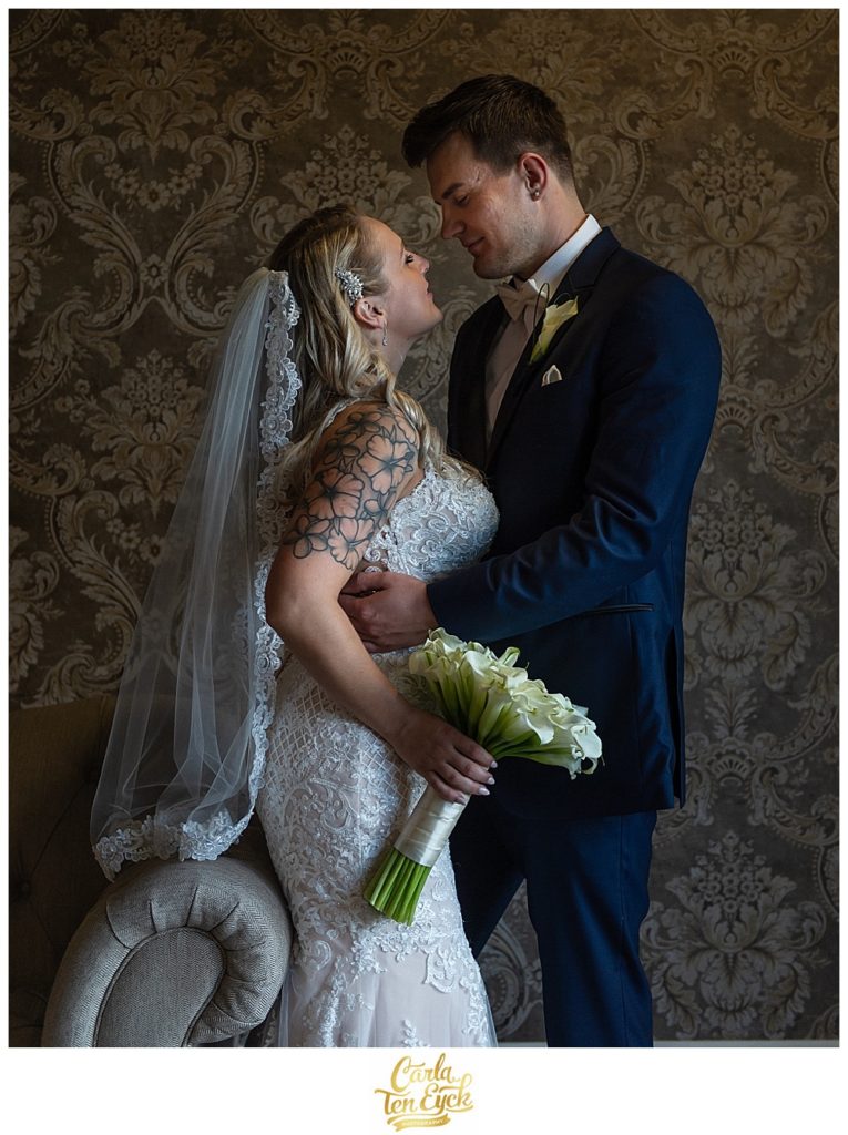 Bride and groom embrace on their wedding day at Aria in Prospect CT