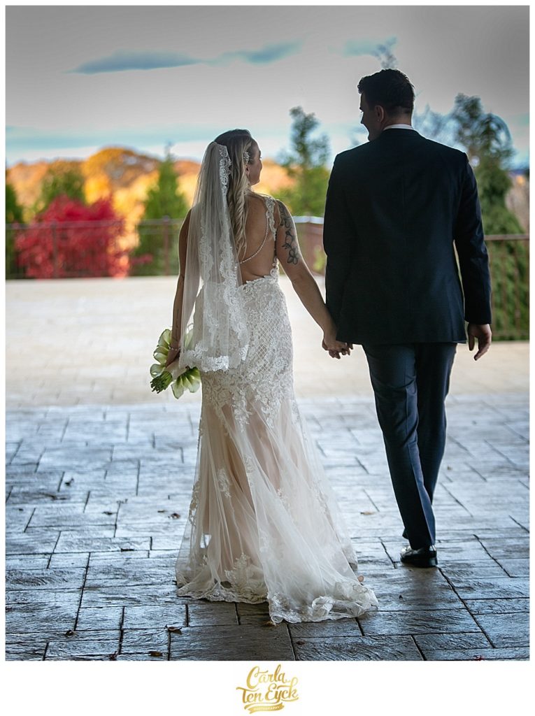 Bride and groom walk on their wedding at Aria in Prospect CT