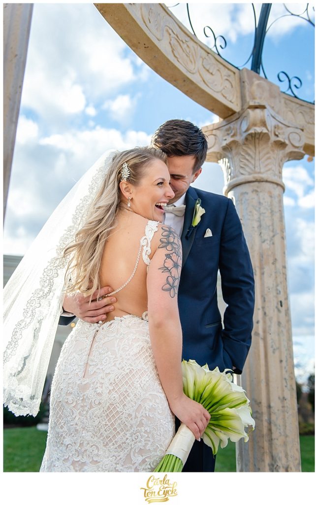 Bride laughs in her Stella York wedding gown and calla lily bouquet on her wedding day at Aria in Prospect CT
