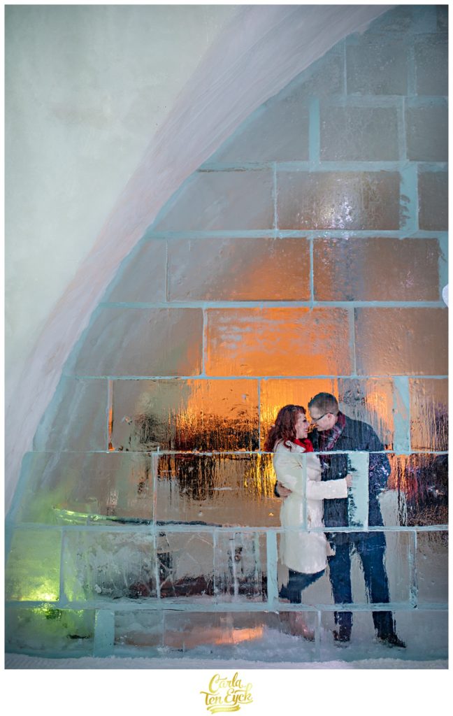 Couple through the ice wall at the ice Hotel de Glace in Montreal Canada 