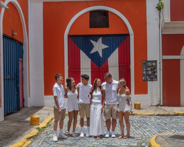 Family portrait in Old San Juan Puerto Rico by the mural of the Puerto Rican Flag