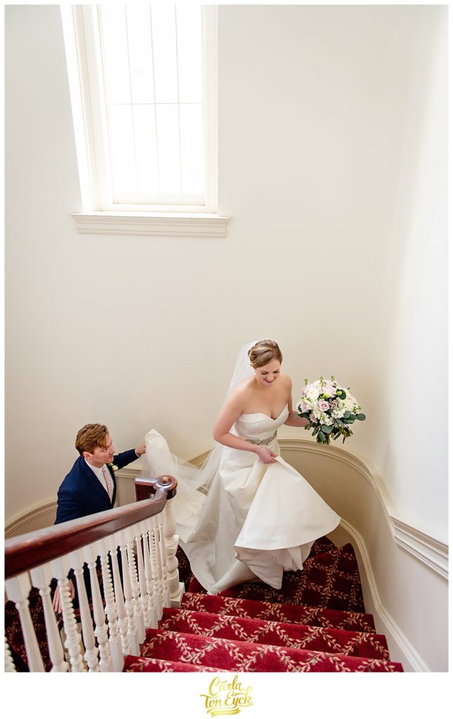 Bride and groom walk up church steps at First Congregational church in Danbury CT after their wedding .