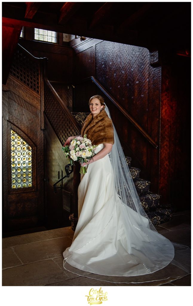 A bride poses in the lobby at her wedding at Le Chateau in South Salem NY.