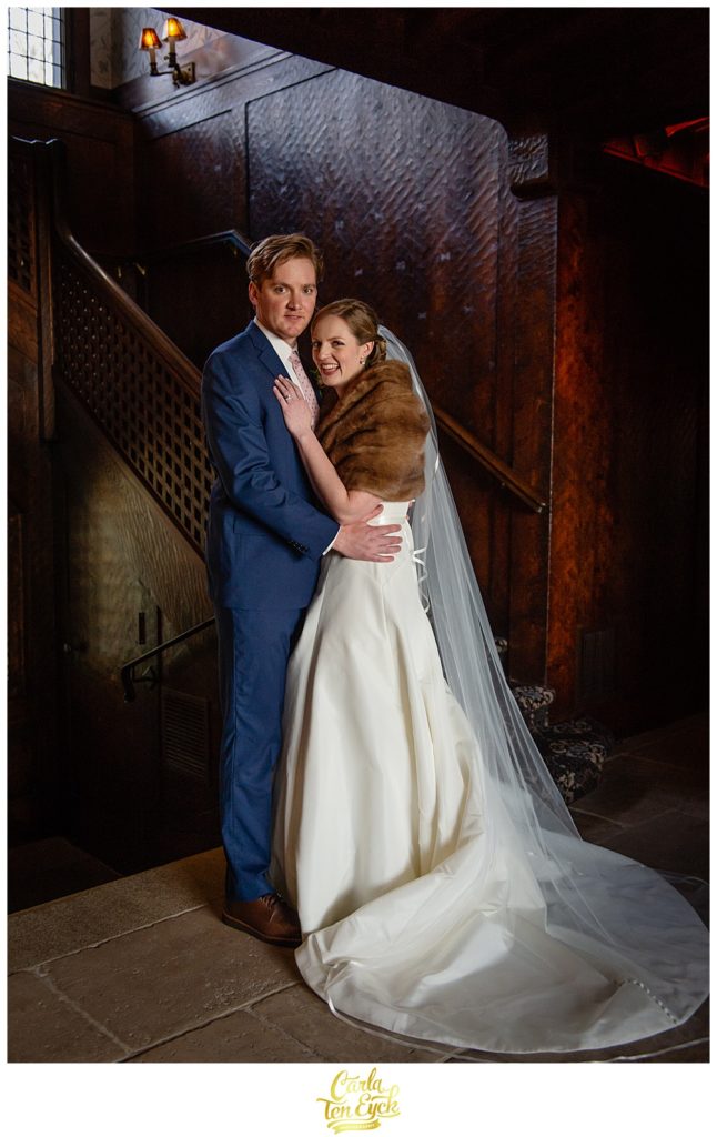 Bride and groom pose in the lobby of Le Chateau in South Salem NY at their wedding reception.