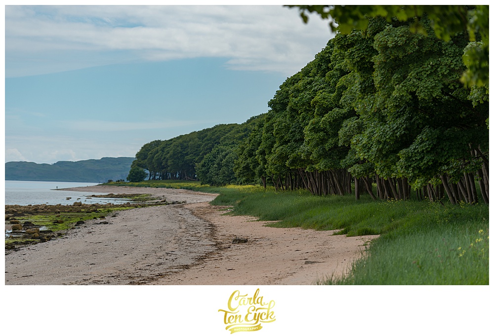 Lush Scottish forests meet the rocky beaches at Mount Stuart Castle on the Isle of Bute Scotland
