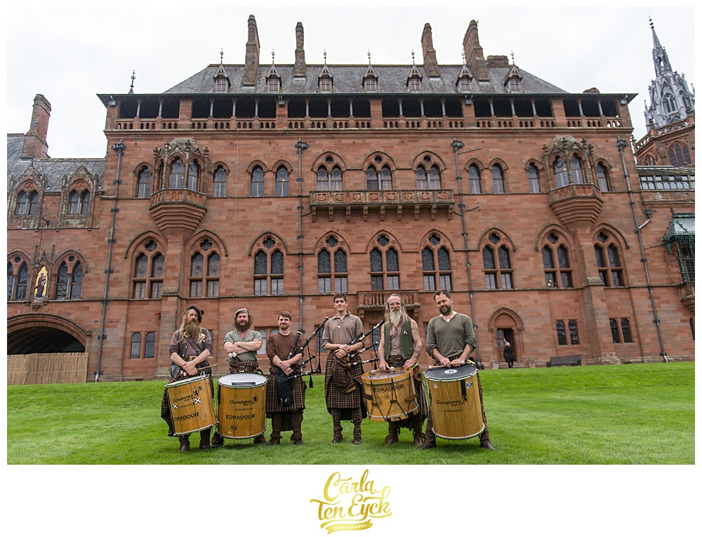 Scottish drummers and bagpipers in front of Mount Stuart Castle on the Isle of Bute Scotland