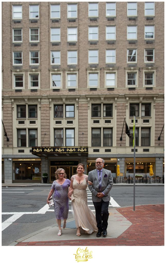 Bride walks to her wedding with her parents at the Boston Public Garden in Boston MA