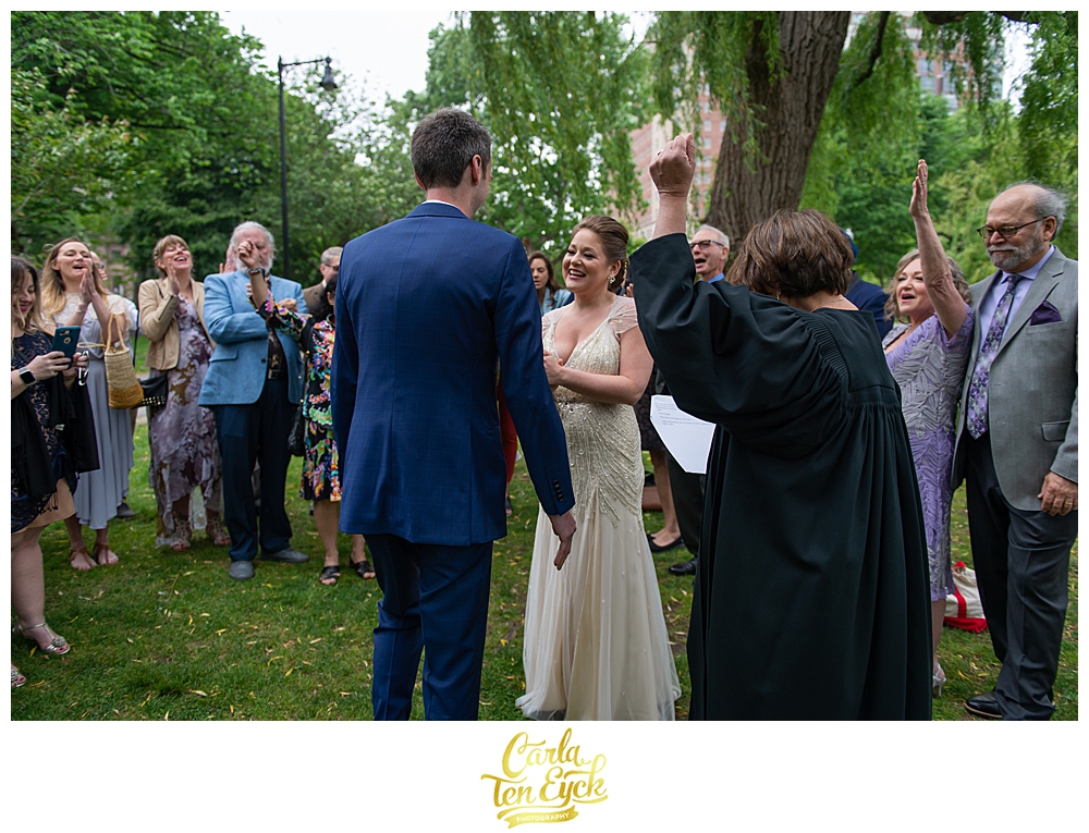 Bride and groom celebrate at their wedding at the Boston Public Garden in Boston MA