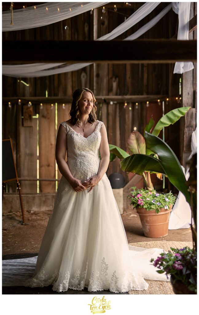 Bride in the tobacco barn after their backyard CT wedding