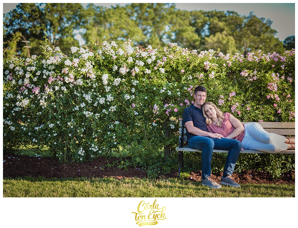 Couple relaxes on a bench in the Elizabeth Park rose garden Hartford CT