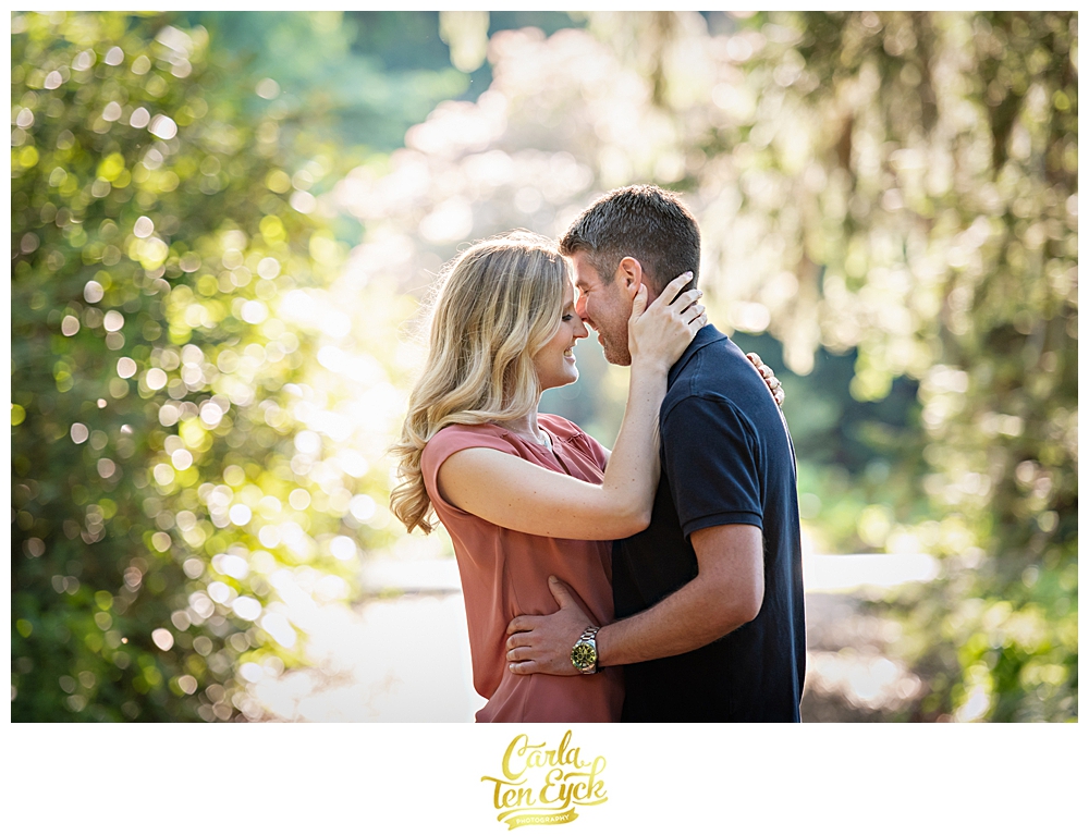 A couple embraces on a wooded path in Elizabeth Park Hartford CT