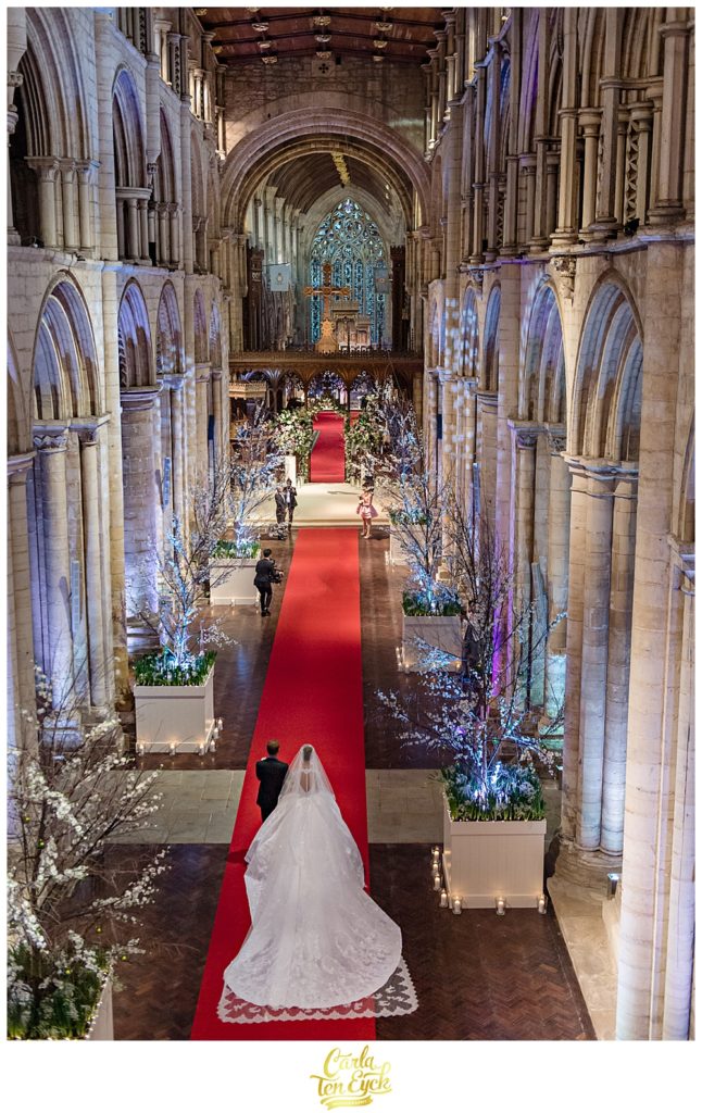 Bride walks down the aisle at her wedding at Selby Abbey Yorkshire UK