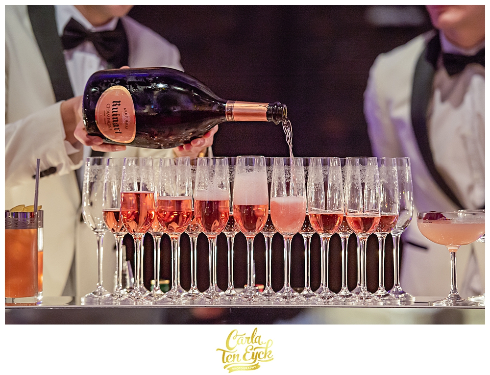 Pink champagne is being poured at a wedding at Selby Abbey in Yorkshire UK