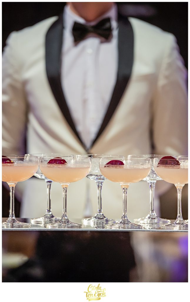 Prosecco and raspberries served by a waiter in a white dinner jacket at Selby Abbey Yorkshire UK