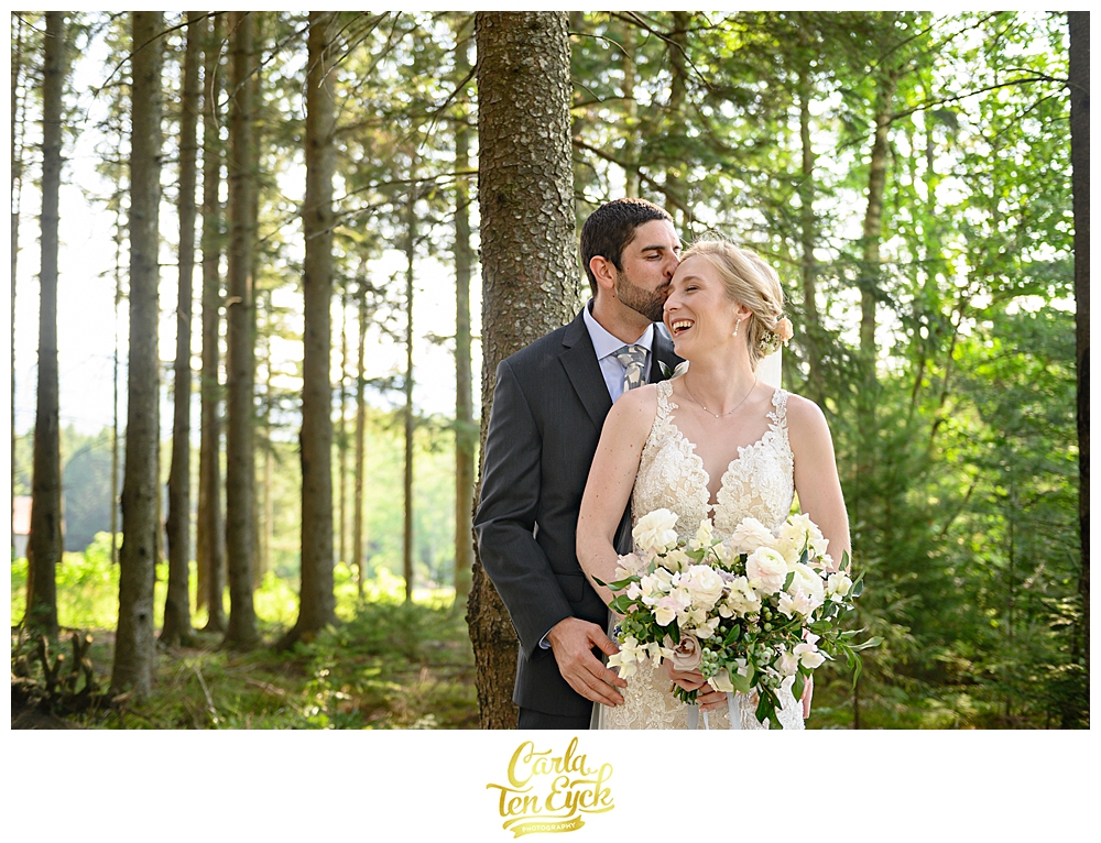 Bride and groom hug at their wedding at Edson Hill in Stowe Vermont