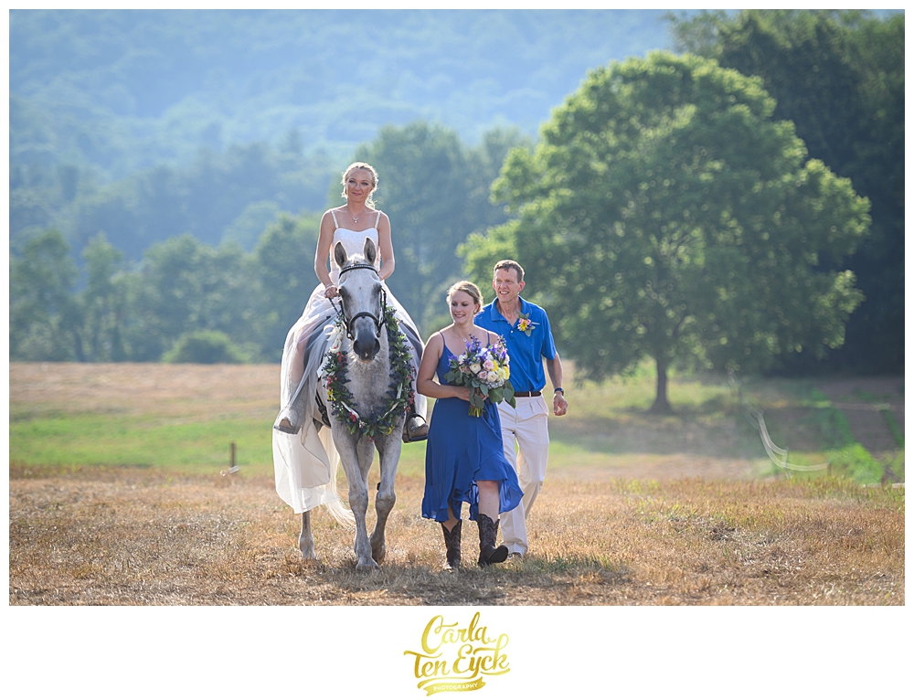 Bride rides down the aisle on her horse at her wedding at Flamig Farm Simsbury CT