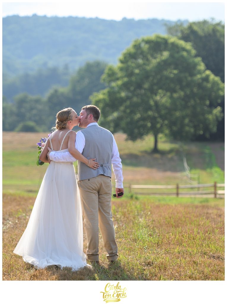 Bride and groom kiss after their wedding ceremony at Flamig Farm Simsbury CT