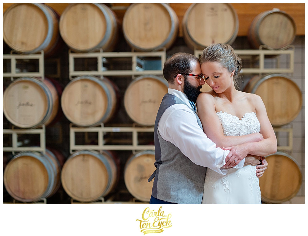 Bride and groom in the barrel room at Jonathan Edwards Winery for their wedding in North Stonington CT