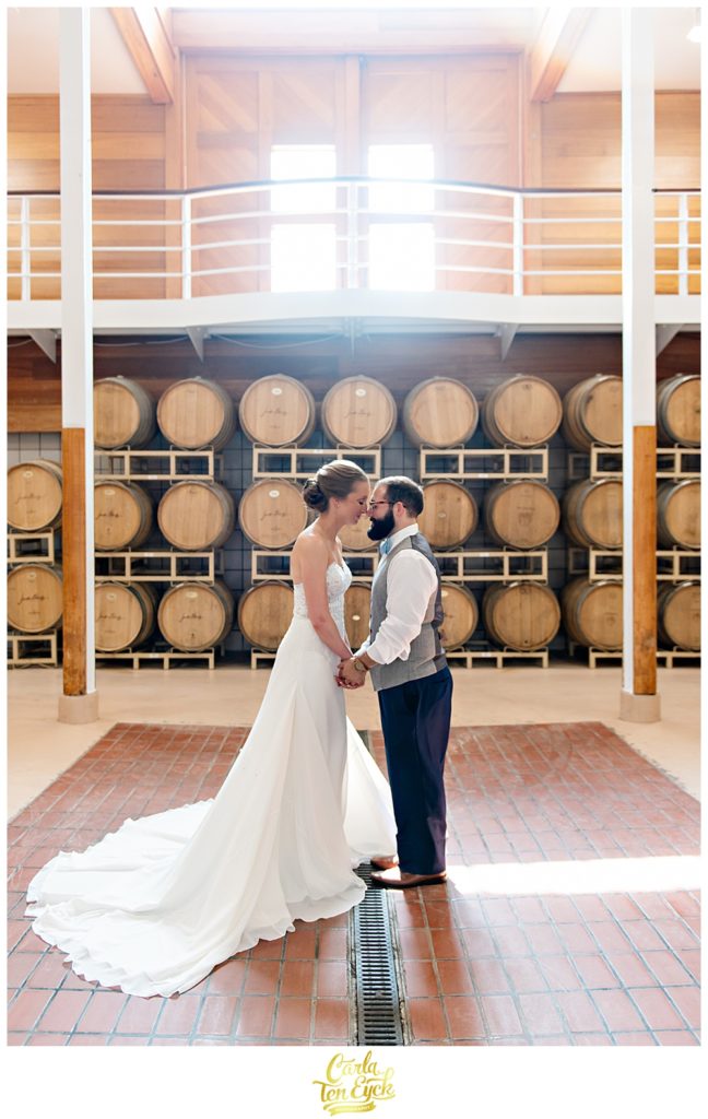 Bride and groom in the barrel room at Jonathan Edwards Winery for their wedding in North Stonington CT