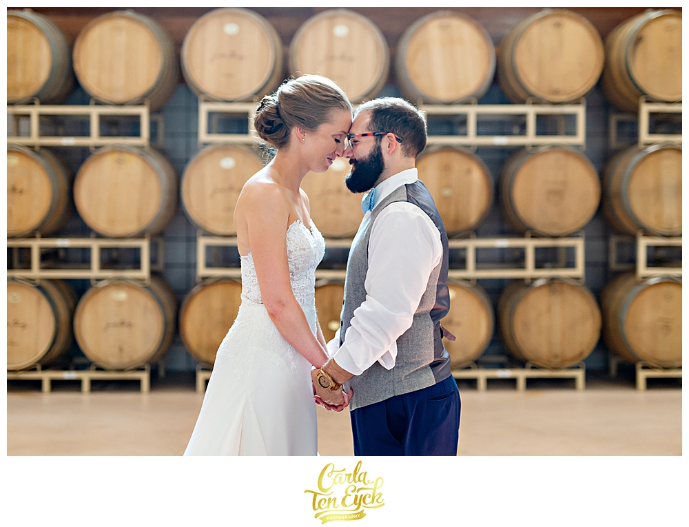 Bride and groom in the barrel room at Jonathan Edwards Winery for their wedding in North Stonington CT