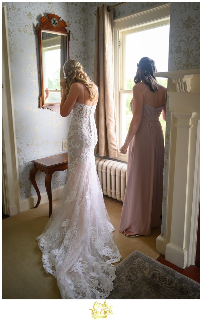 Bride looks in the mirror in her wedding gown by Maggie Sottero at the Inn at Mystic, Mystic CT
