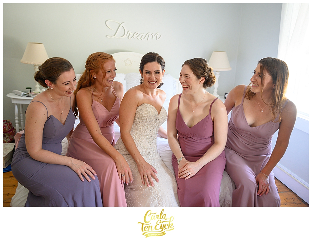 Bride and bridesmaids laugh while getting ready at a wedding at The Owenego Inn in Branford CT
