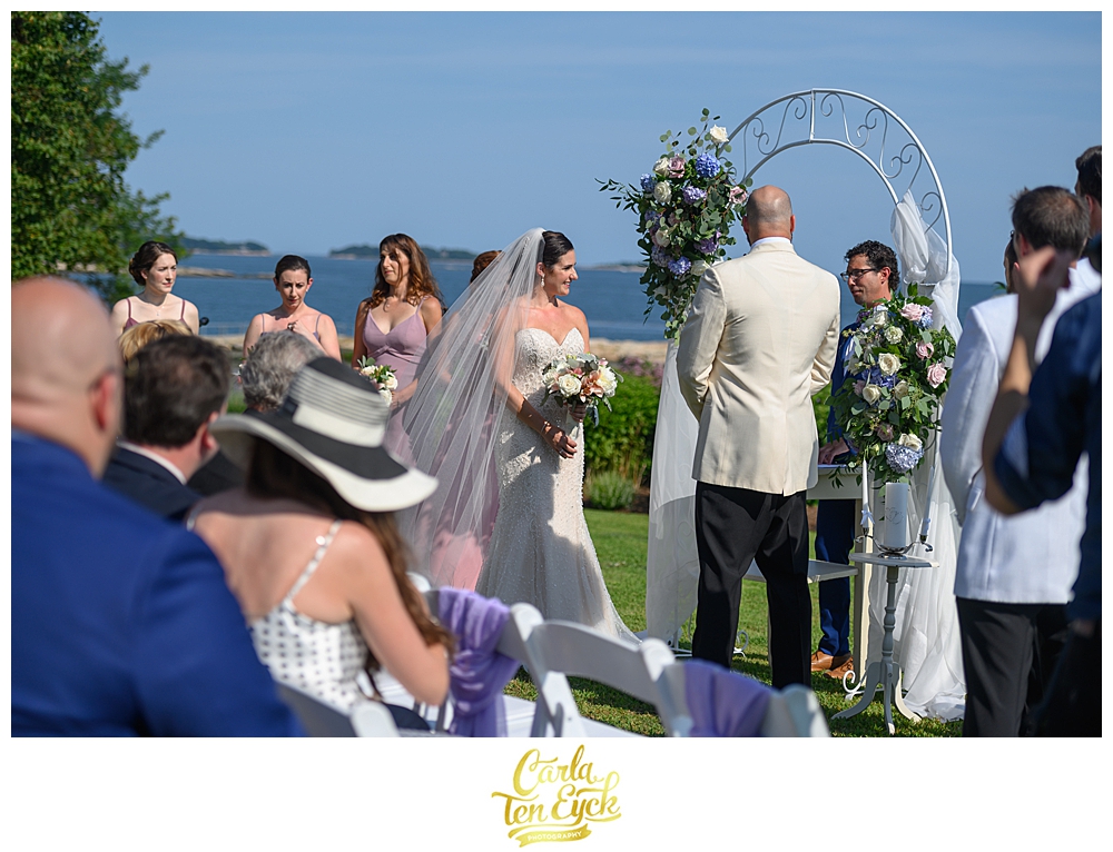 Bride and groom during their outdoor wedding ceremony at The Owenego Inn in Branford CT