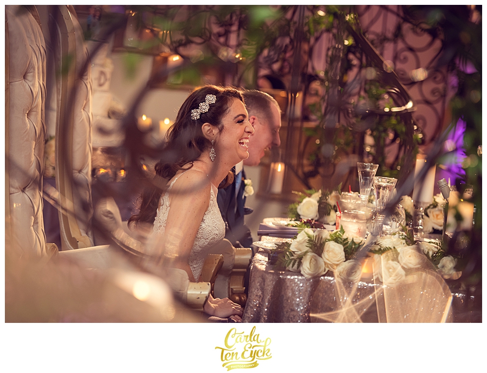 A bride laughs during toasts at her wedding at Aria in Prospect CT