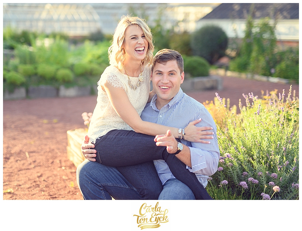 A couple snuggles in the herb garden in Elizabeth Park during their CT engagement session in Hartford CT