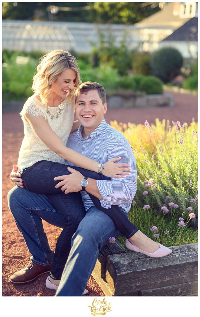 A couple snuggles in the herb garden in Elizabeth Park during their CT engagement session in Hartford CT