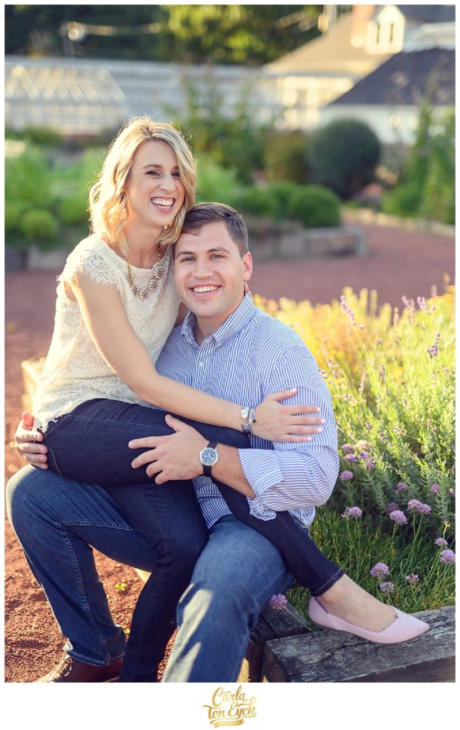 A couple snuggles in the herb garden in Elizabeth Park during their CT engagement session in Hartford CT