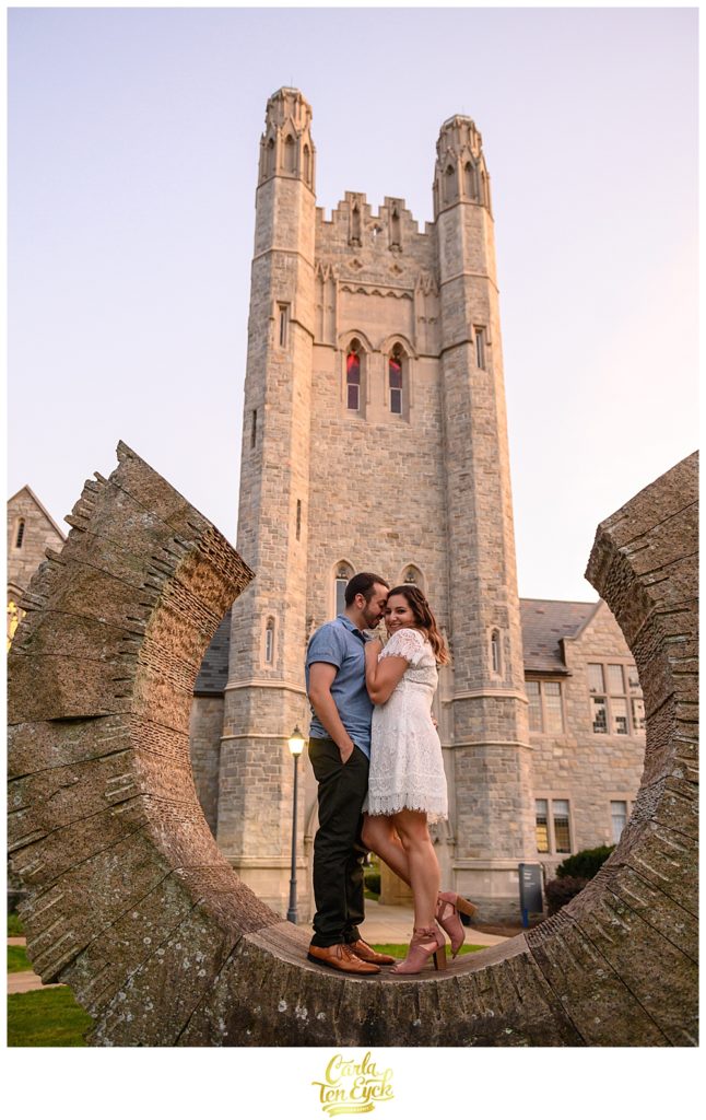 A couple snuggles on a sculpture on the campus of the UCONN Law School in Hartford CT