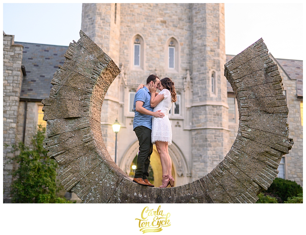 A couple embraces during their engagement session at the UCONN Law School's campus in the historic West End neighborhood of Hartford CT