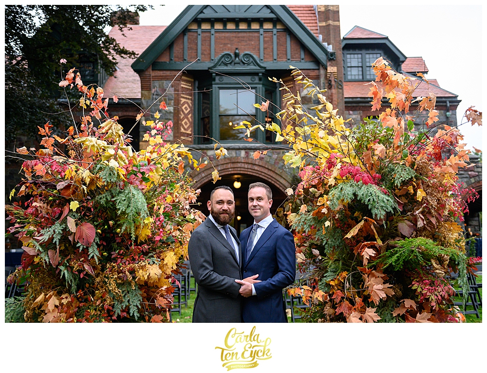 Tow grooms embrace at their wedding at the Eustis Estate in Milton MA