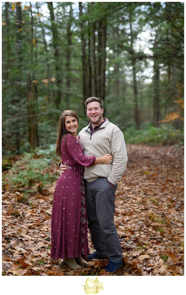 Couple snuggles in the woods at Valley View farms in Haydenville MA